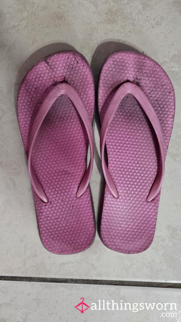 Well Worn Pink Flip Flops With Toe Prints